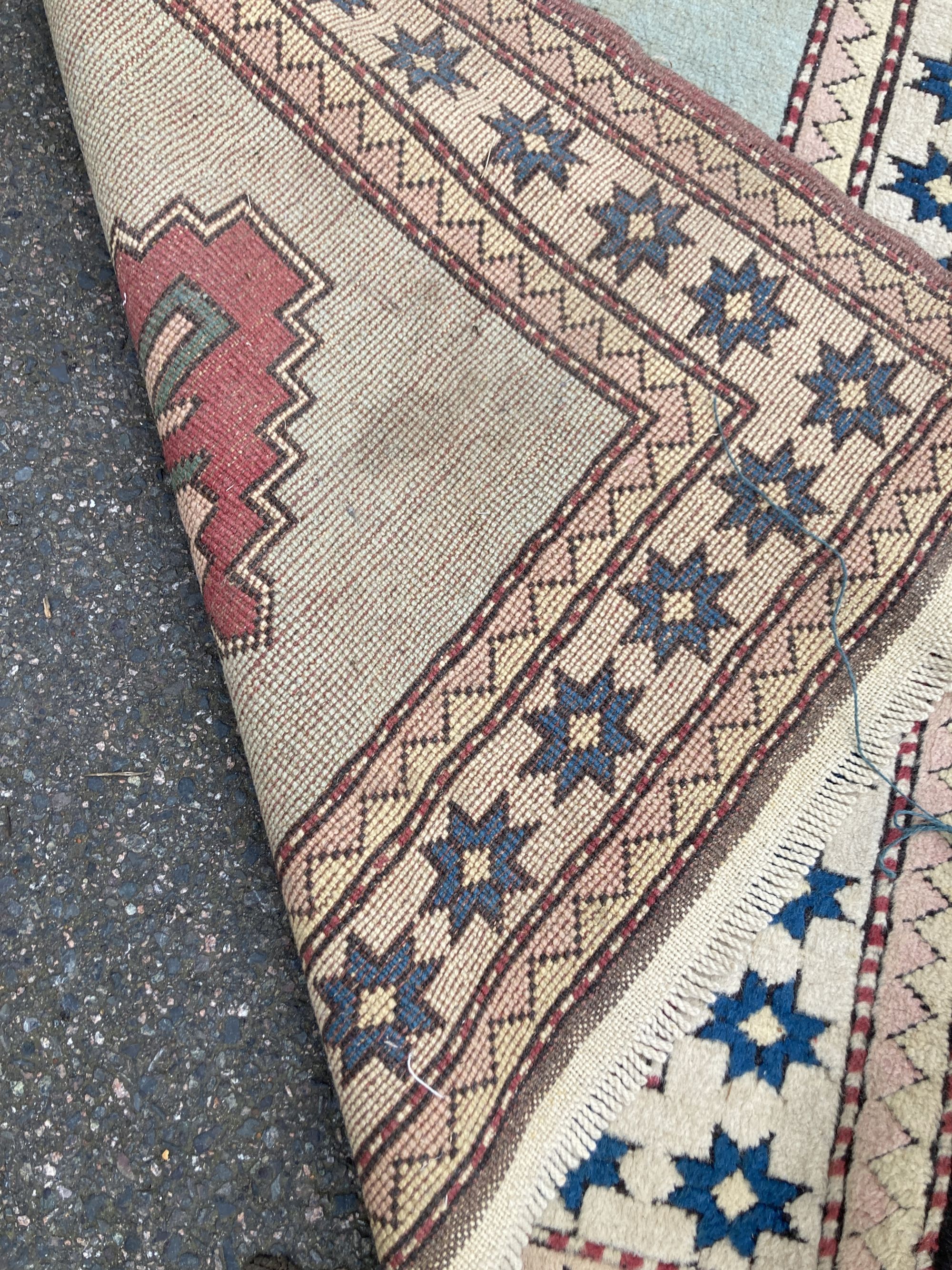 A Chinese Tabriz style carpet having burgundy central medallion on a foliate ivory ground, and a small Turkish rug